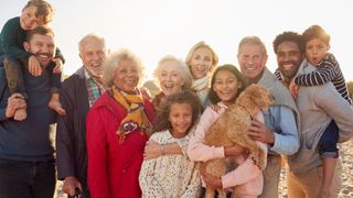 large family with dog on beach