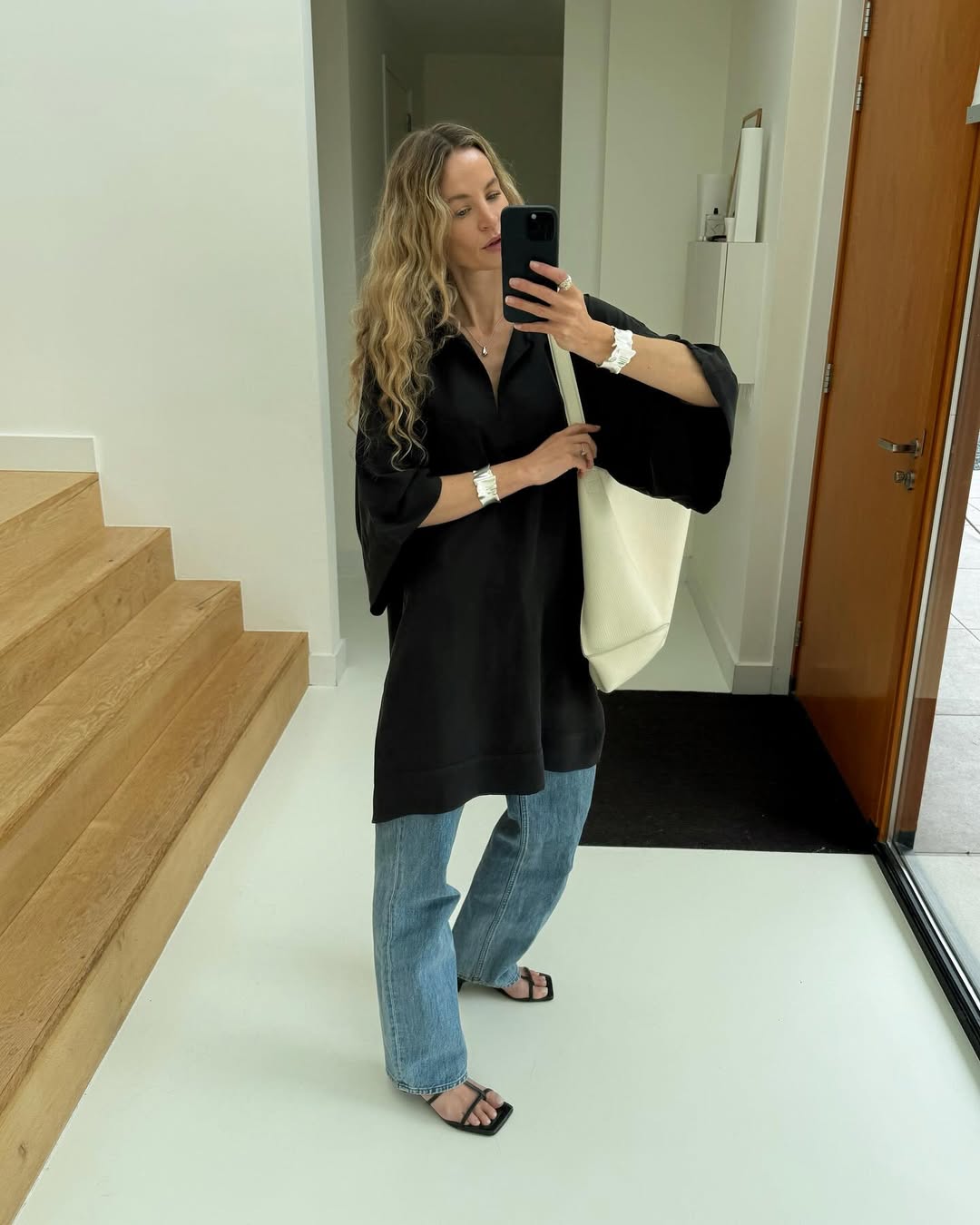 influencer outfit photo featuring a white handbag