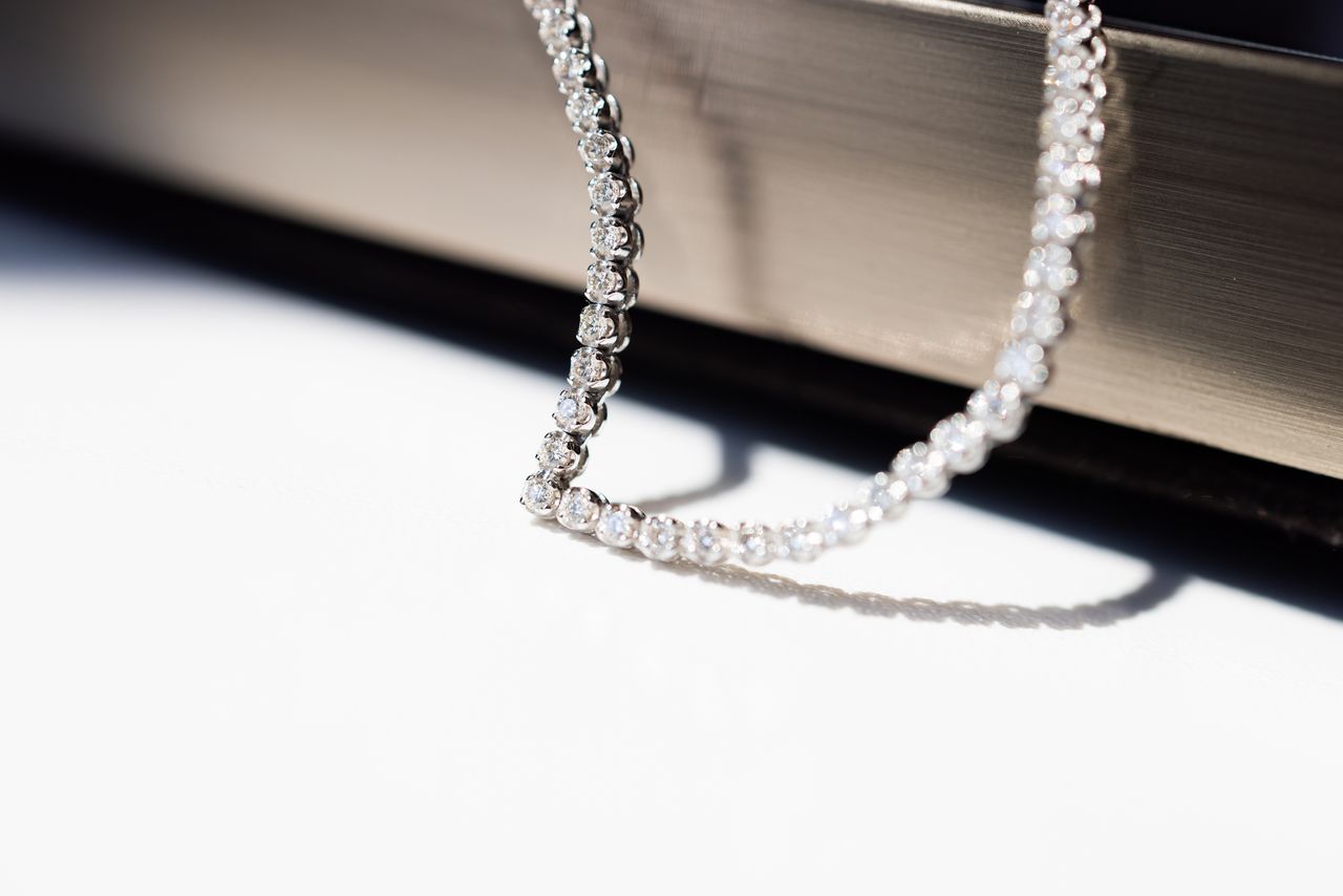 Close up shot minimal diamond necklace. Concept for luxury accessory