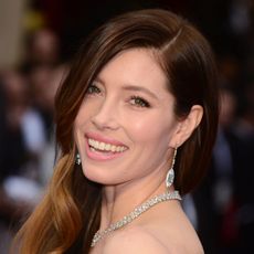 Smiling Jessica Biel wearing a diamond necklace and earrings