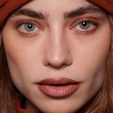 model with blue eyes wearing copper eyeshadow