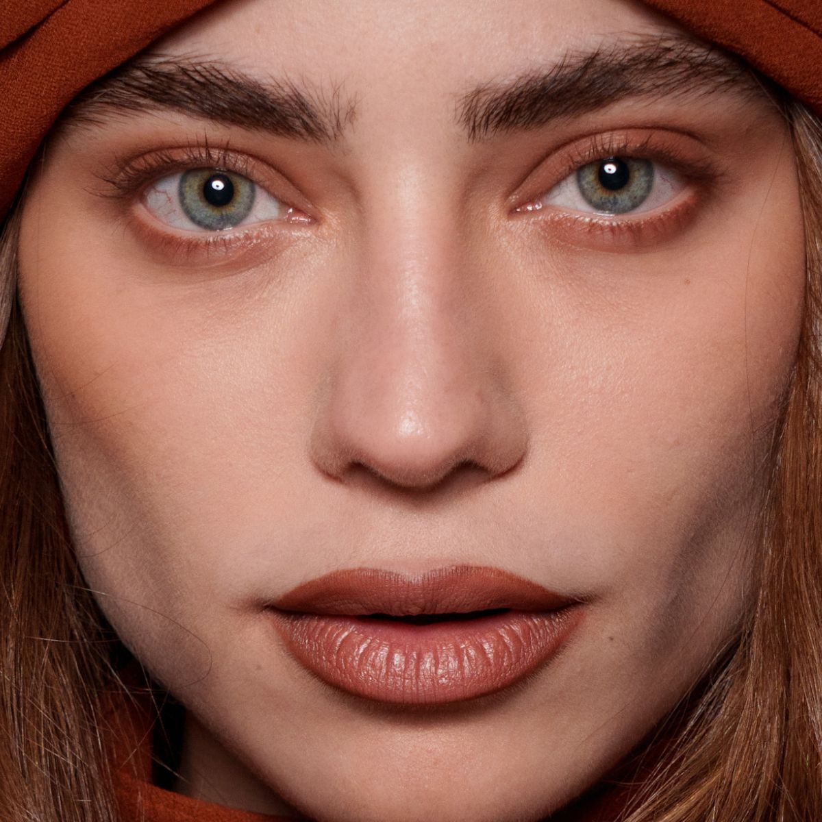 model with blue eyes wearing copper eyeshadow