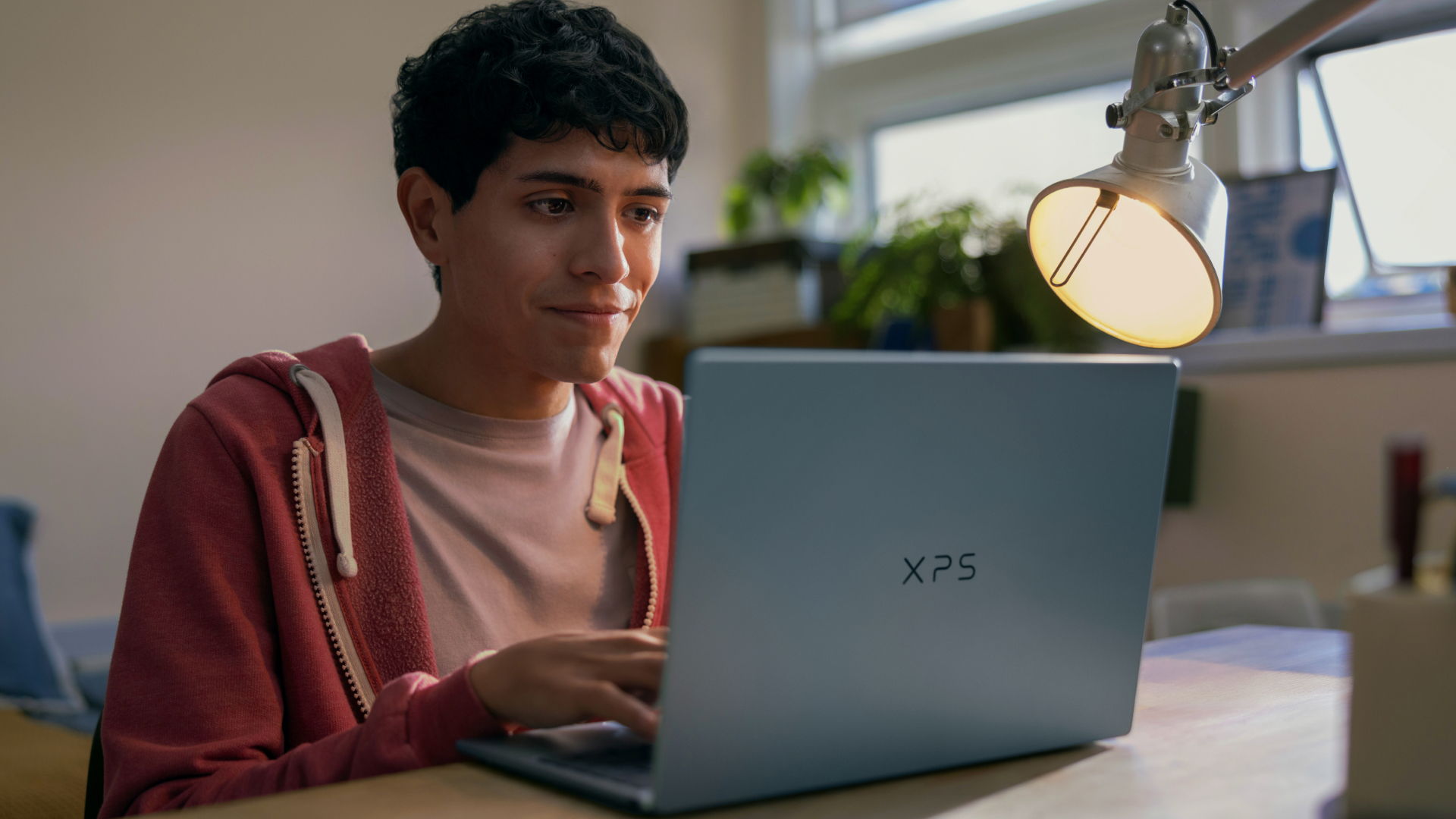 Dell XPS 13 laptop being used by a young person at a desk