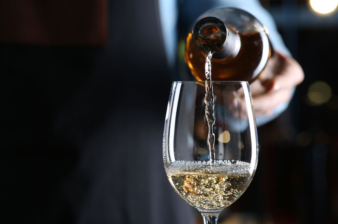 Pouring a glass of white wine