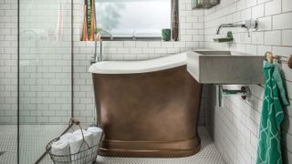 small deep copper bath in small bathroom