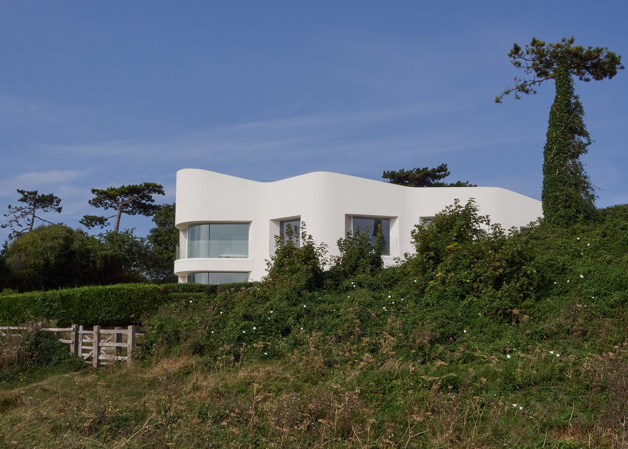 whit rendered self build with greenery around