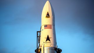 The nose cone of an Astra rocket with its arrow logo and U.S. flag