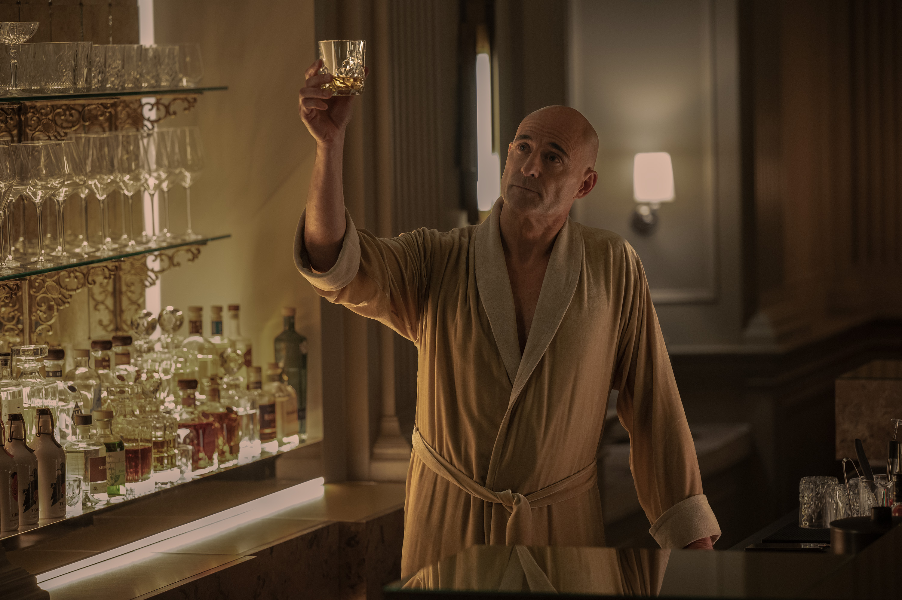 mark strong as david wearing a robe and doing a toast in nine perfect strangers season 2