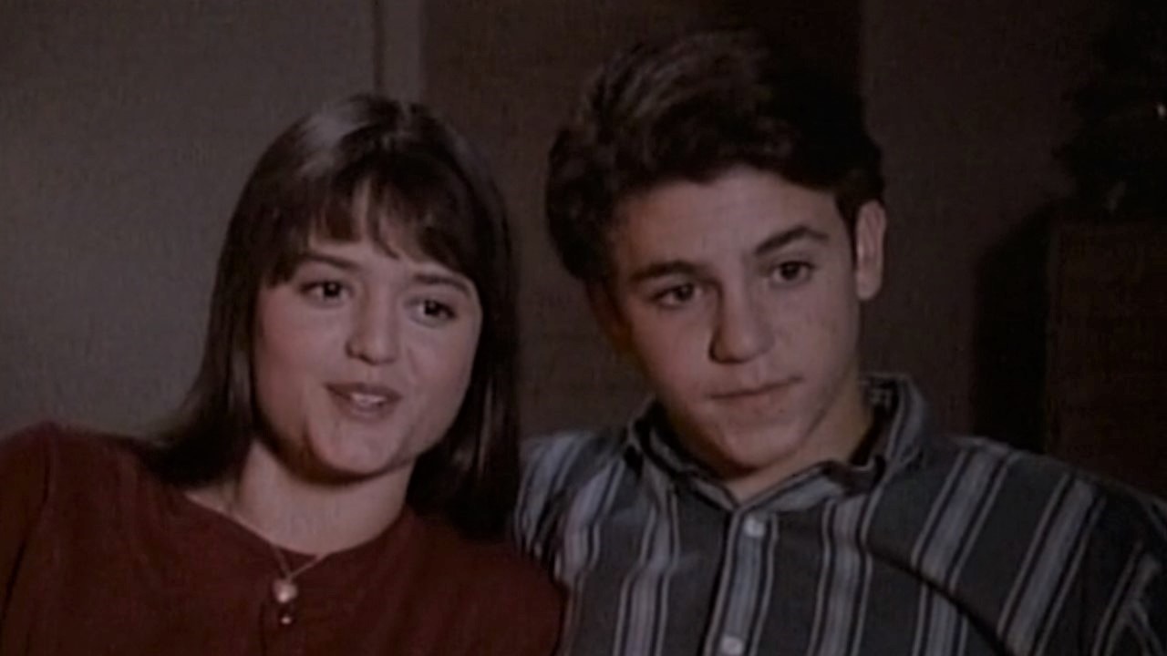 Winnie and Kevin sitting close on couch on The Wonder Years