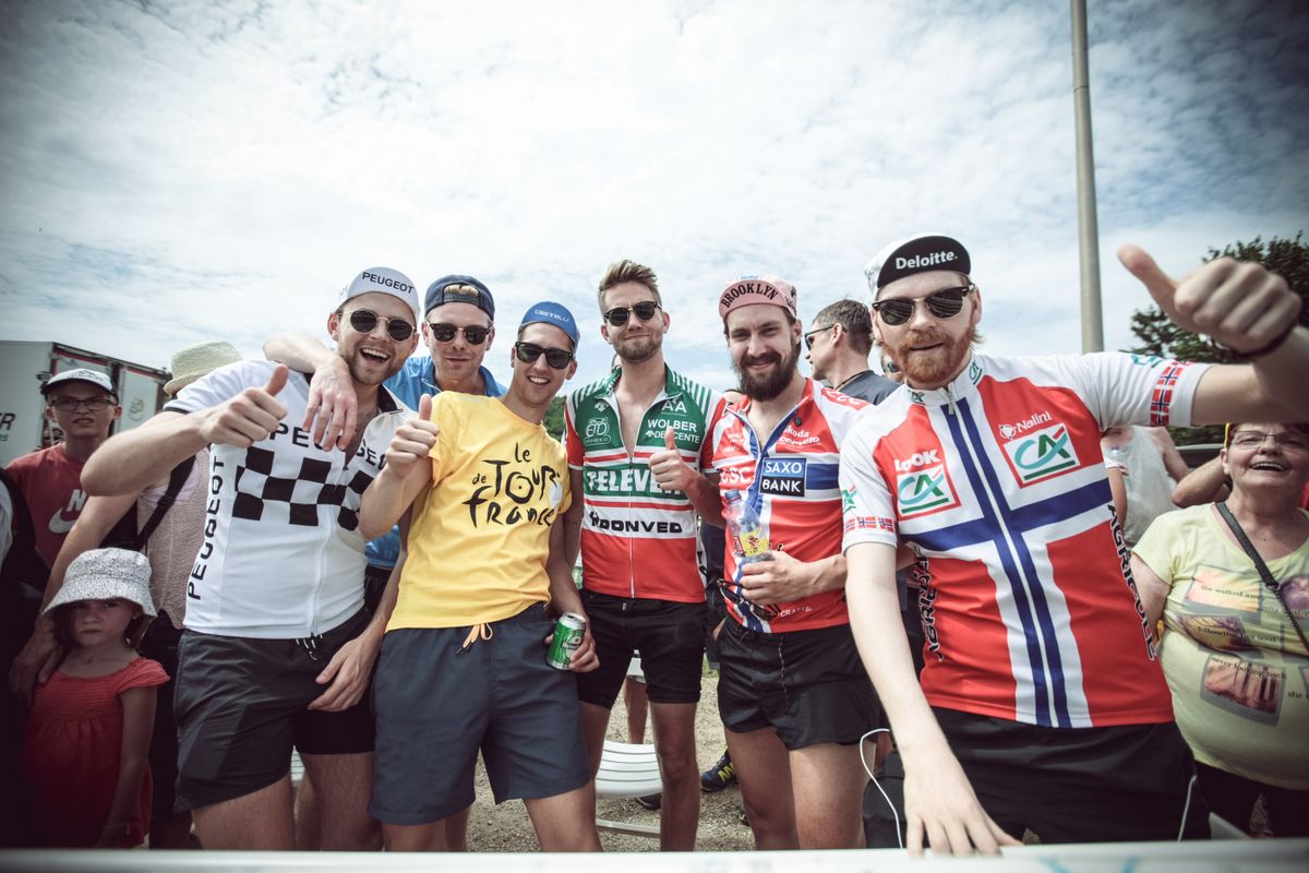 A collective of Norwegian fans cheer on from the roadside