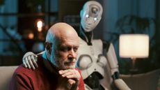 Sad lonely man at home alone sitting on the couch with his caring AI robot