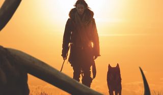 Alpha Kodi Smit McPhee traveling in the sunset with his wolf