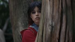 Jenna Ortega partially behind a tree in Death of a Unicorn