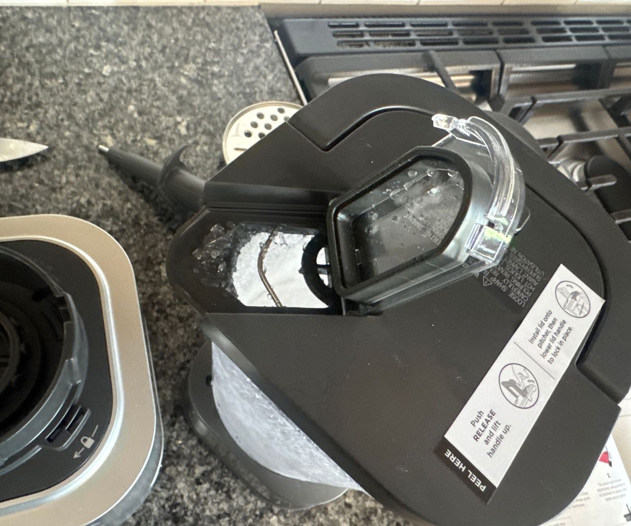 The top spout flap of the Ninja Foodi Power Blender Ultimate System pitcher lifted ready for pouring.