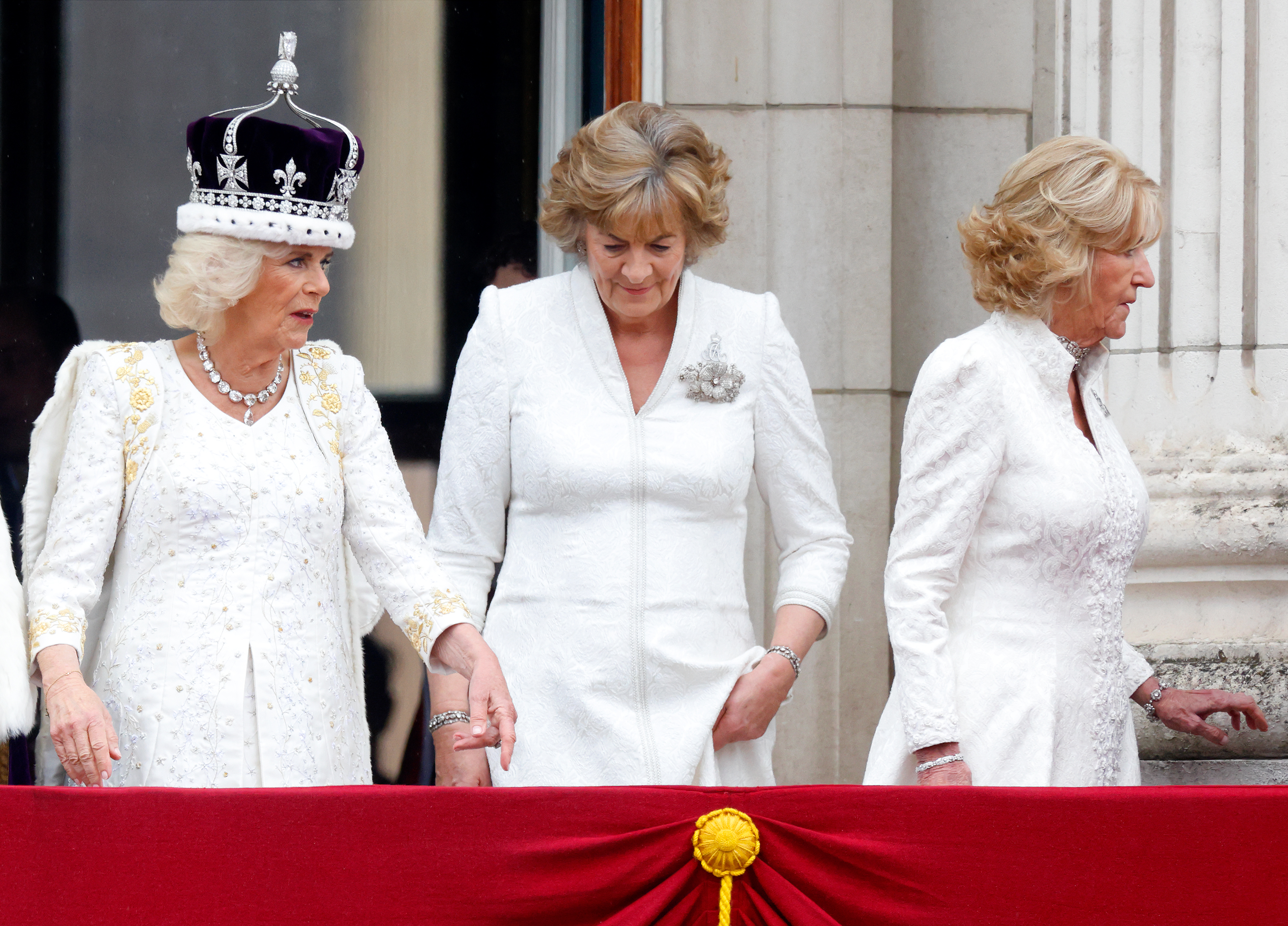 Queen Camilla, Fiona Shelburne, Marchioness of Lansdowne and Annabel Elliot watch an RAF flypast from the balcony of Buckingham Palace following the Coronation on May 6, 2023 in London, England.