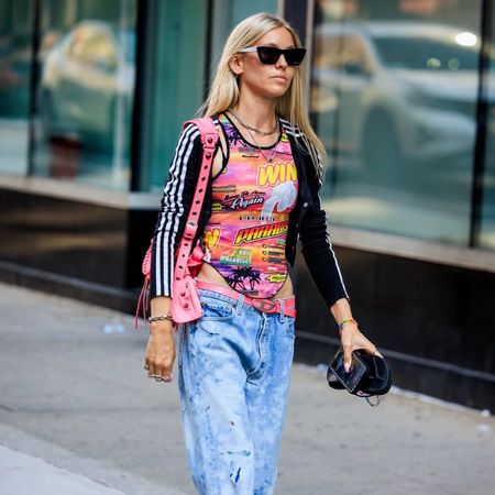 Jessica minkoff wearing sunglasses, adidas bolero, graphic tank and jeans