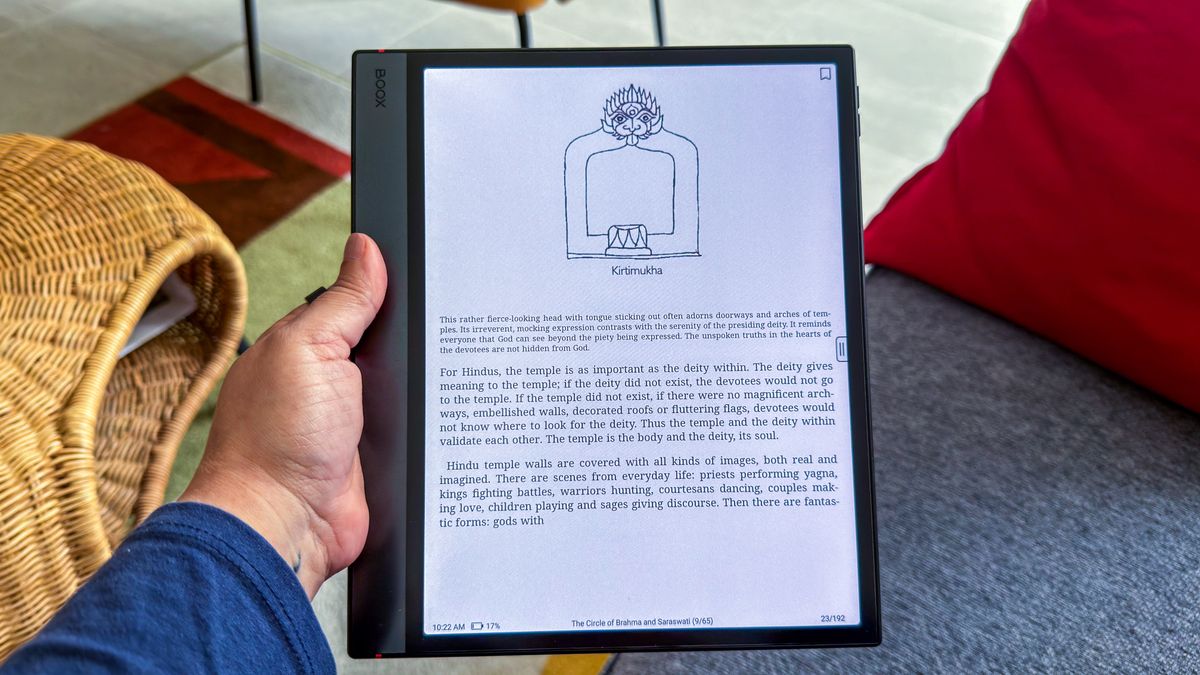 A person holding the Boox Note Air5 C that's displaying a page of a book