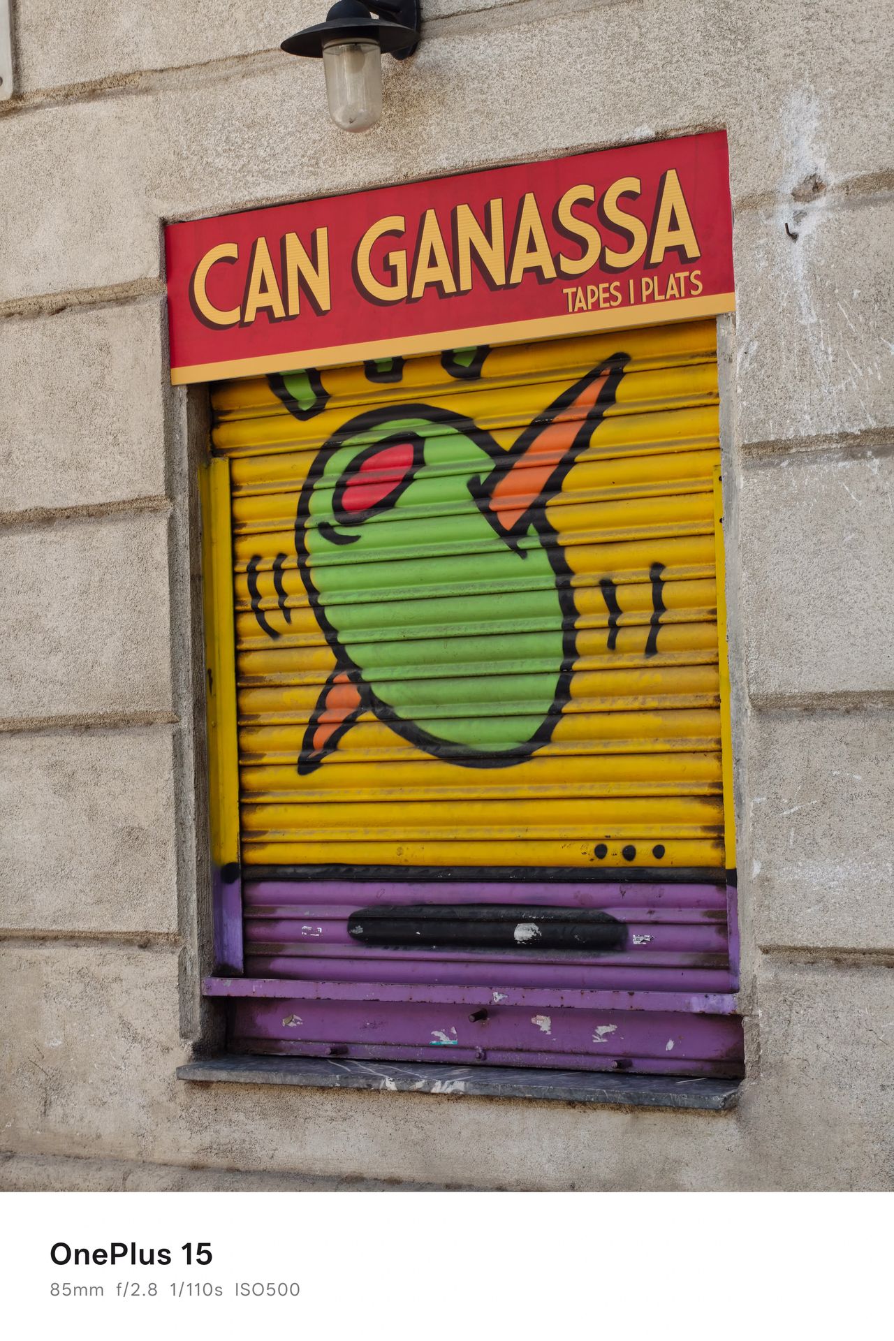 Graffiti of an olive on shutters outside a restaurant called Can Ganassa in Barcelona, Spain