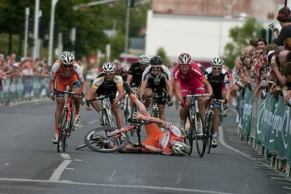 Down and out: Joel Pearson (Genesys Wealth Advisers) hit the road hard in the sprint to the line in the mens' elite race.