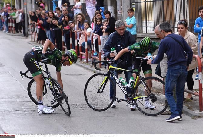 Riders inspect their bikes after a crash.