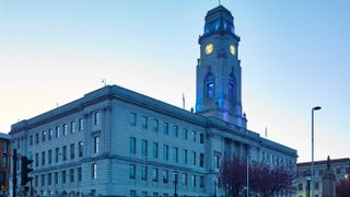 A photo taken of Barnsley Council Town Hall, taken from the ground looking up at the building. Decorative: the photo was taken at dusk.