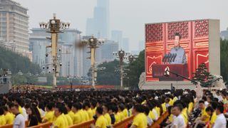 A screen shows Xi Jinping making a speech during celebrations marking 100 years of the CCP