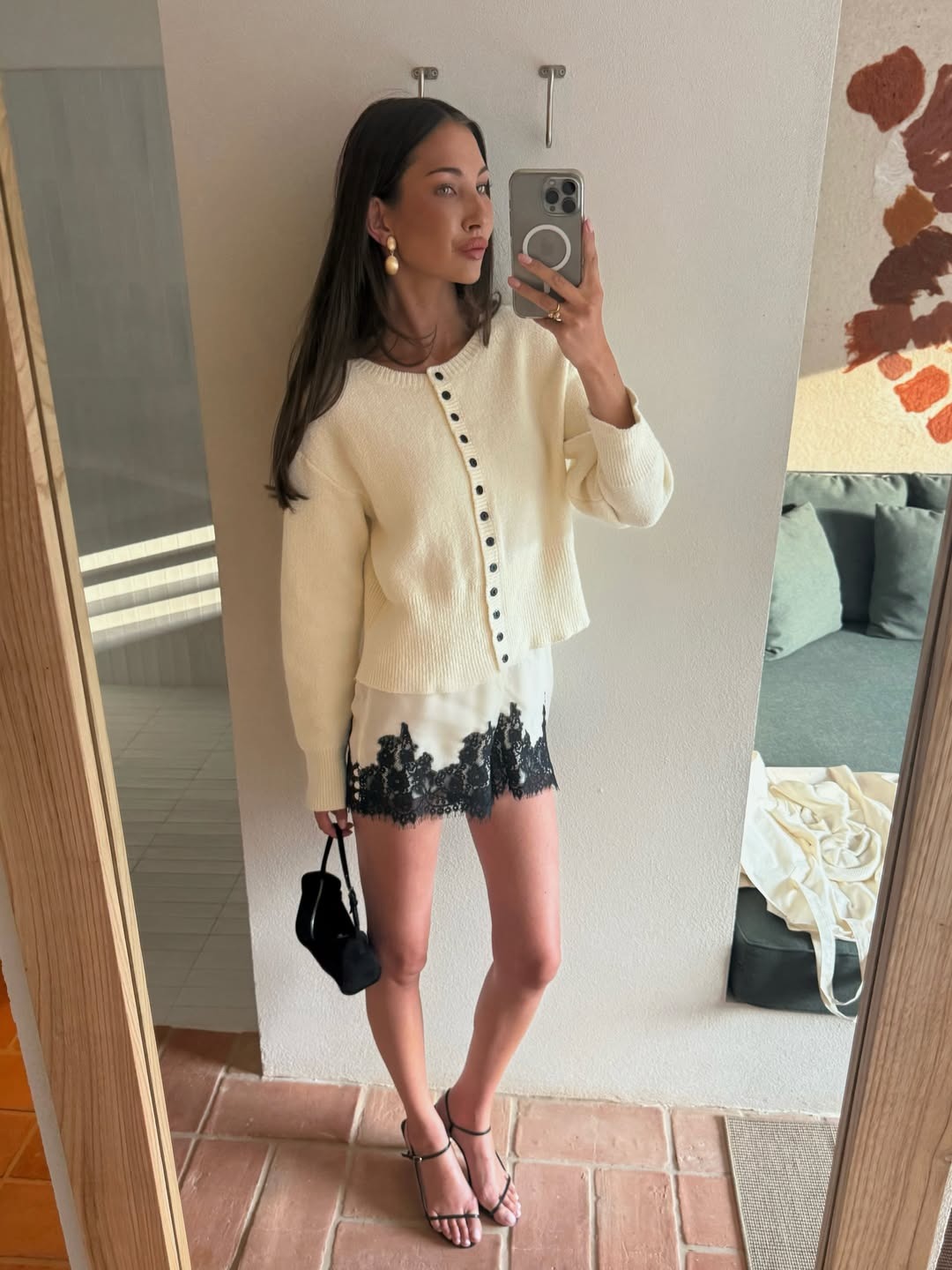 Influencer wearing a cardigan with satin lace-trim shorts.