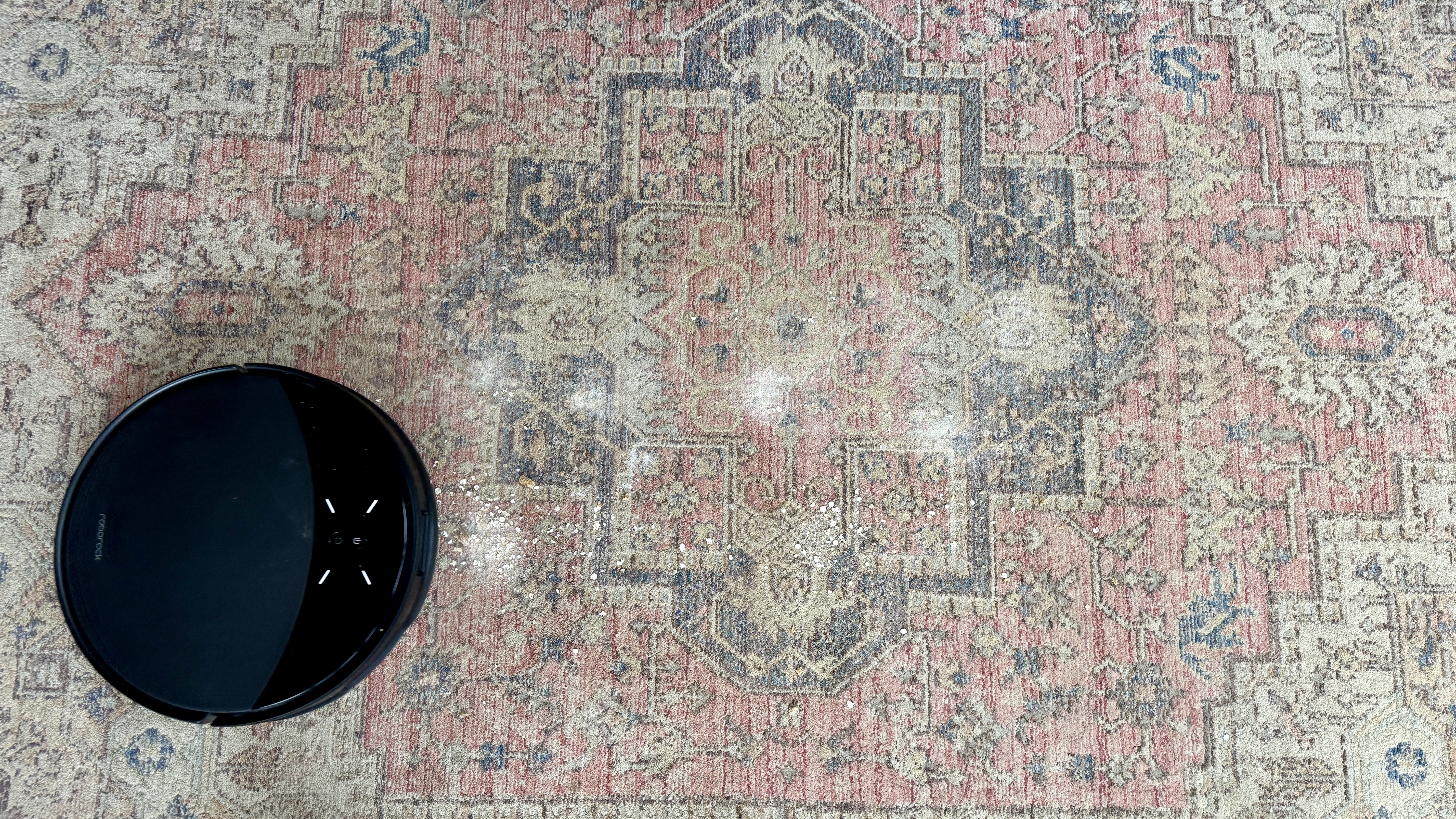 Roborock Saros 10R robot vacuum and mop before completing vacuuming test on carpet