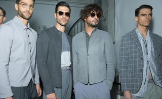 Group of models in a studio all wearing shades of grey