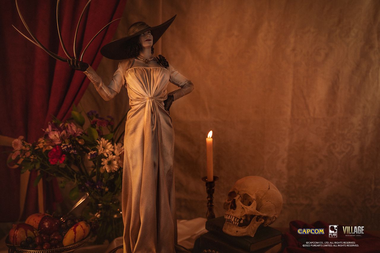 lady d statue with candle and skull in background