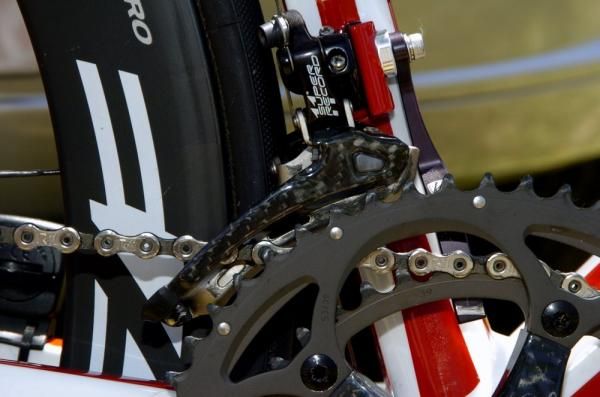 The Campagnolo Super Record front derailleur features a carbon fibre chain guide.
