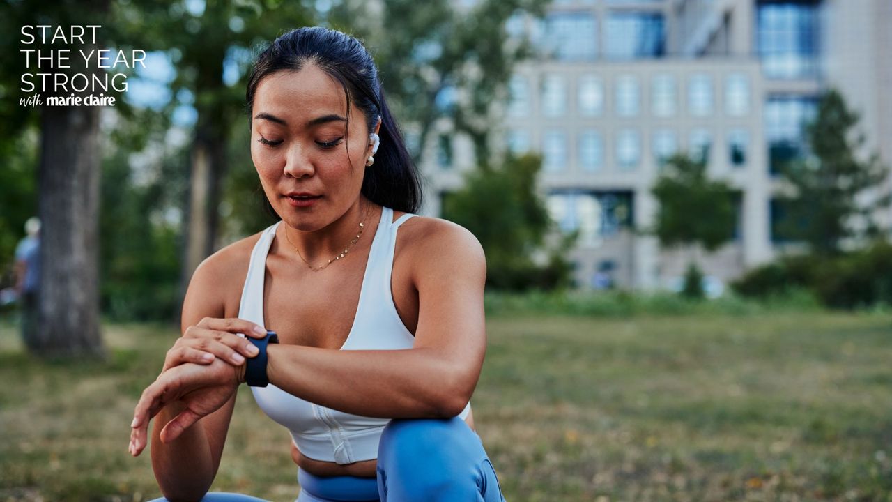 A woman looking at her fitness tracker after a workout