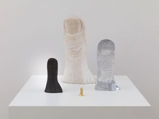 Four models of the artist's thumb in different sizes and materials