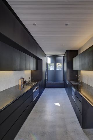 The kitchen's perspective-led design points all lines to the structure's sculptural front window feature