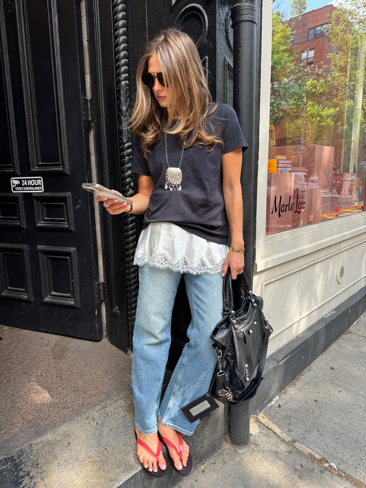 Women in black t-shirt, camisole slip and jeans