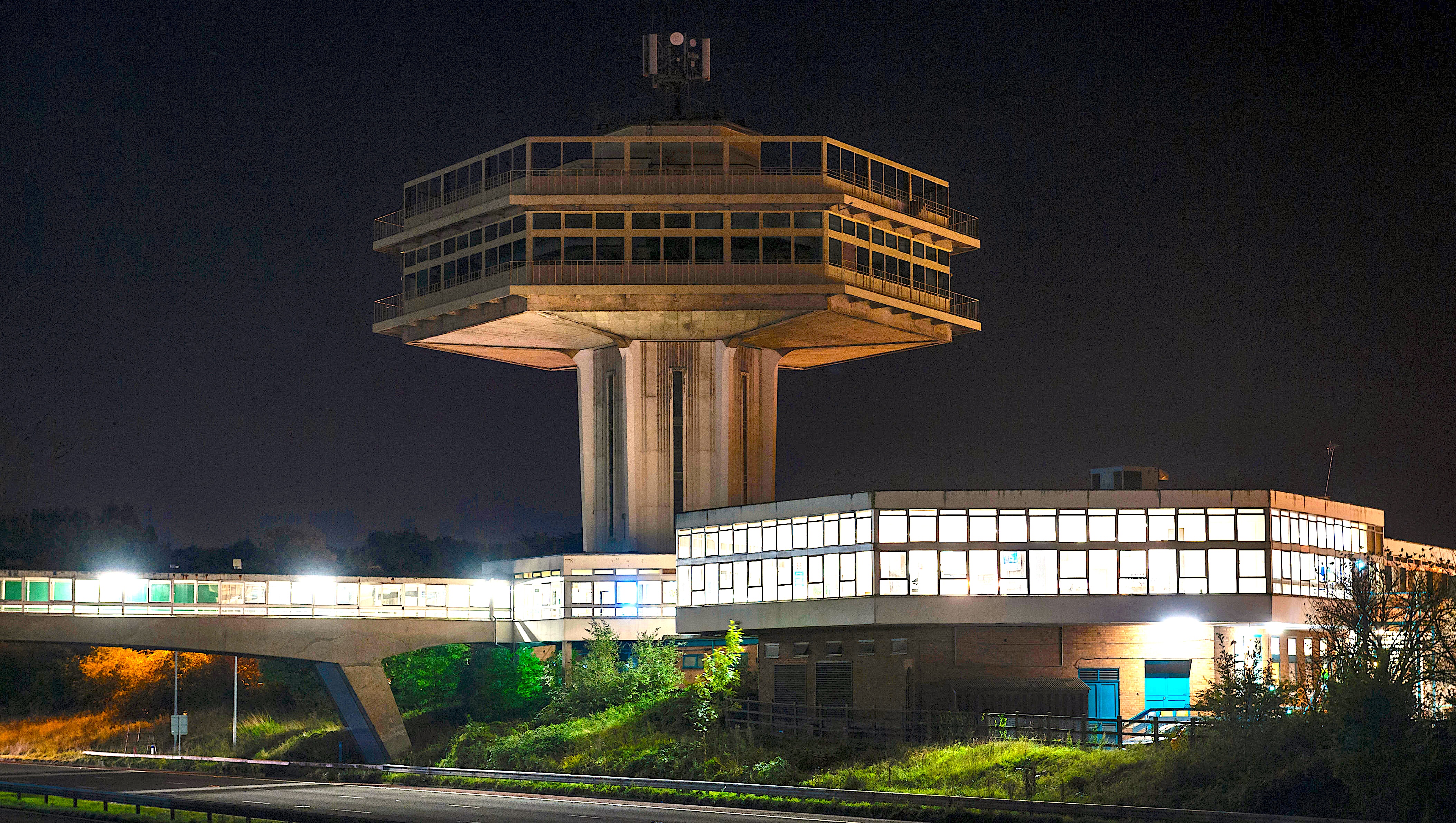 Lancaster (Forton) Services, UK, M6 motorway at night. The Pennine Tower restaurant (1965) is a listed building (now closed)