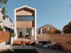 Exterior with wood features, patio and outdoor furniture of the Edmonds + Lee house