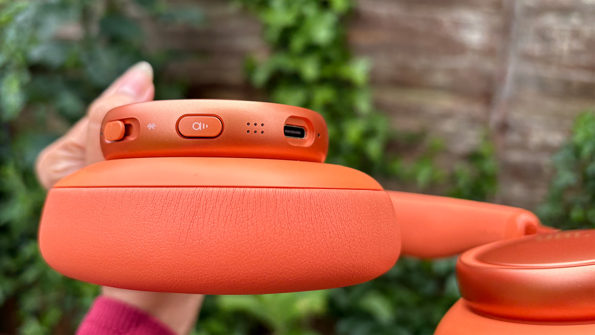 JBL Live 780NC wireless headphones with close-up on buttons and controls on earcup