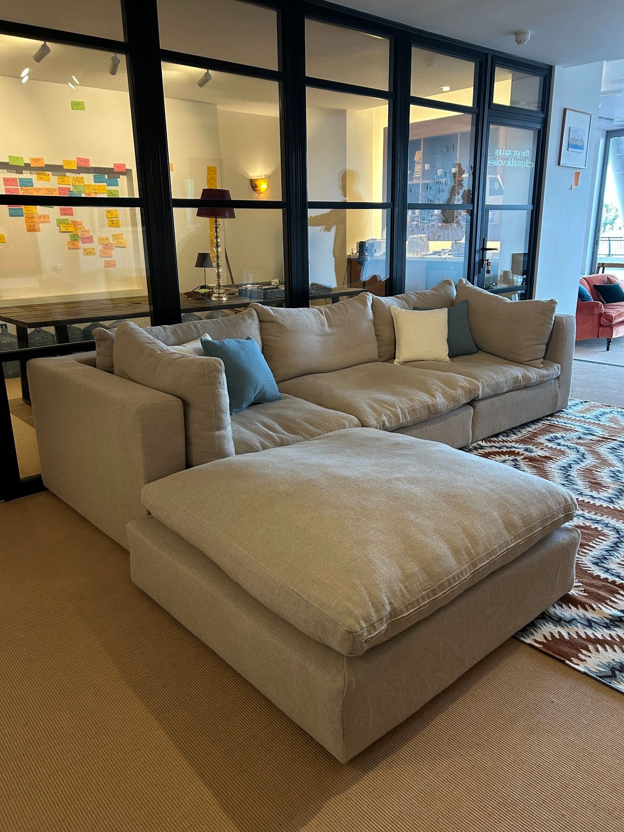 Schplendid Big Bonnie modular sofa in flax linen, featuring an ottoman displayed in the brand&rsquo;s showroom.