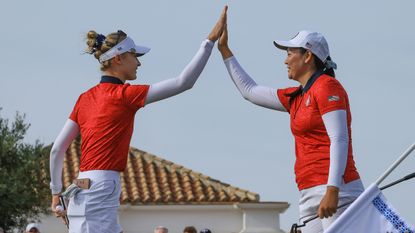 Nelly Korda and Allisen Corpuz hi-five at the Solheim Cup