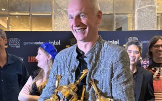 Swen Vincke with an armful of Golden Joystick Awards.