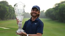 Tommy Fleetwood poses with the DP World India Championship trophy
