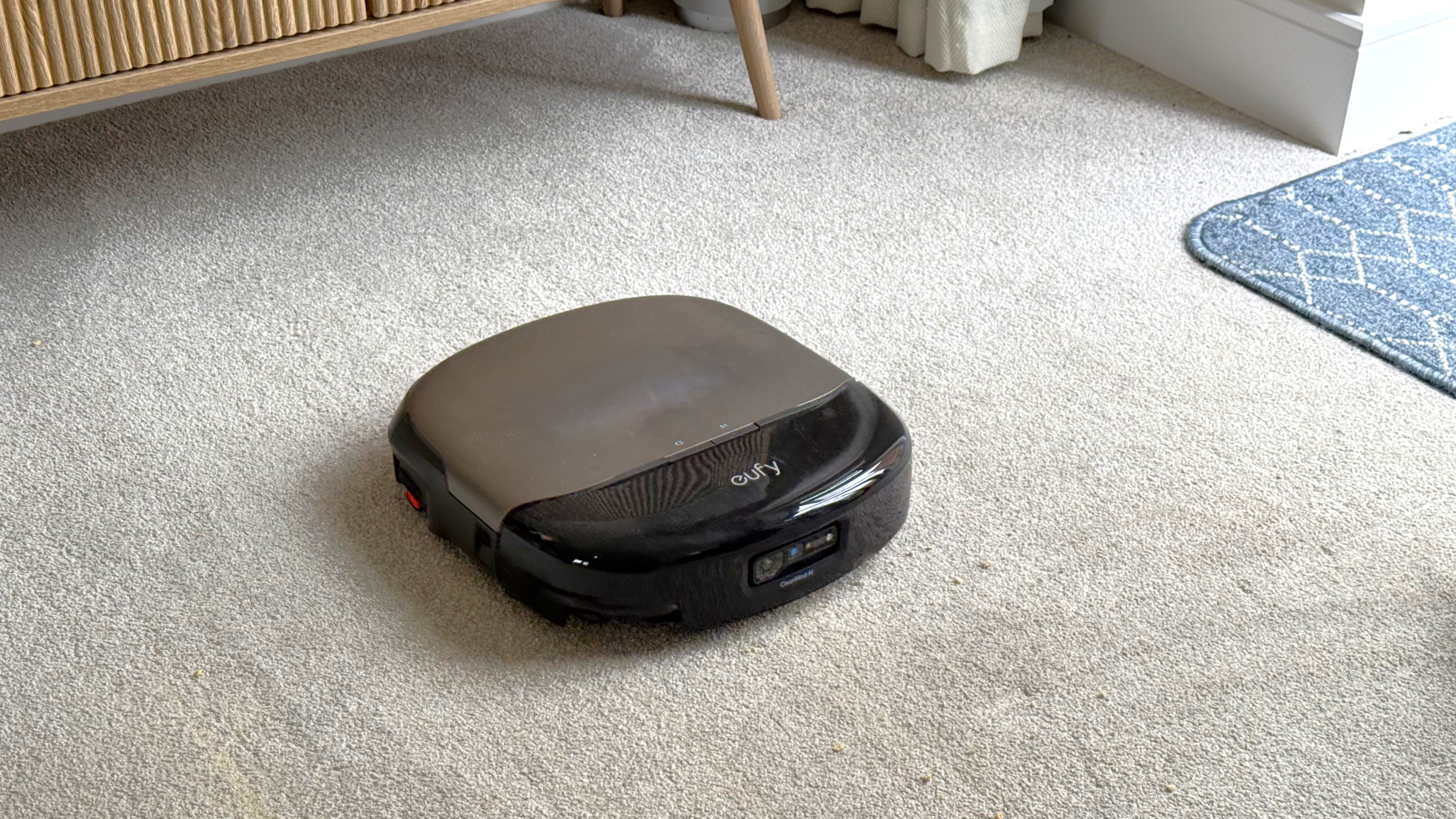 Eufy Omni S2 robot vacuum cleaning a carpeted floor