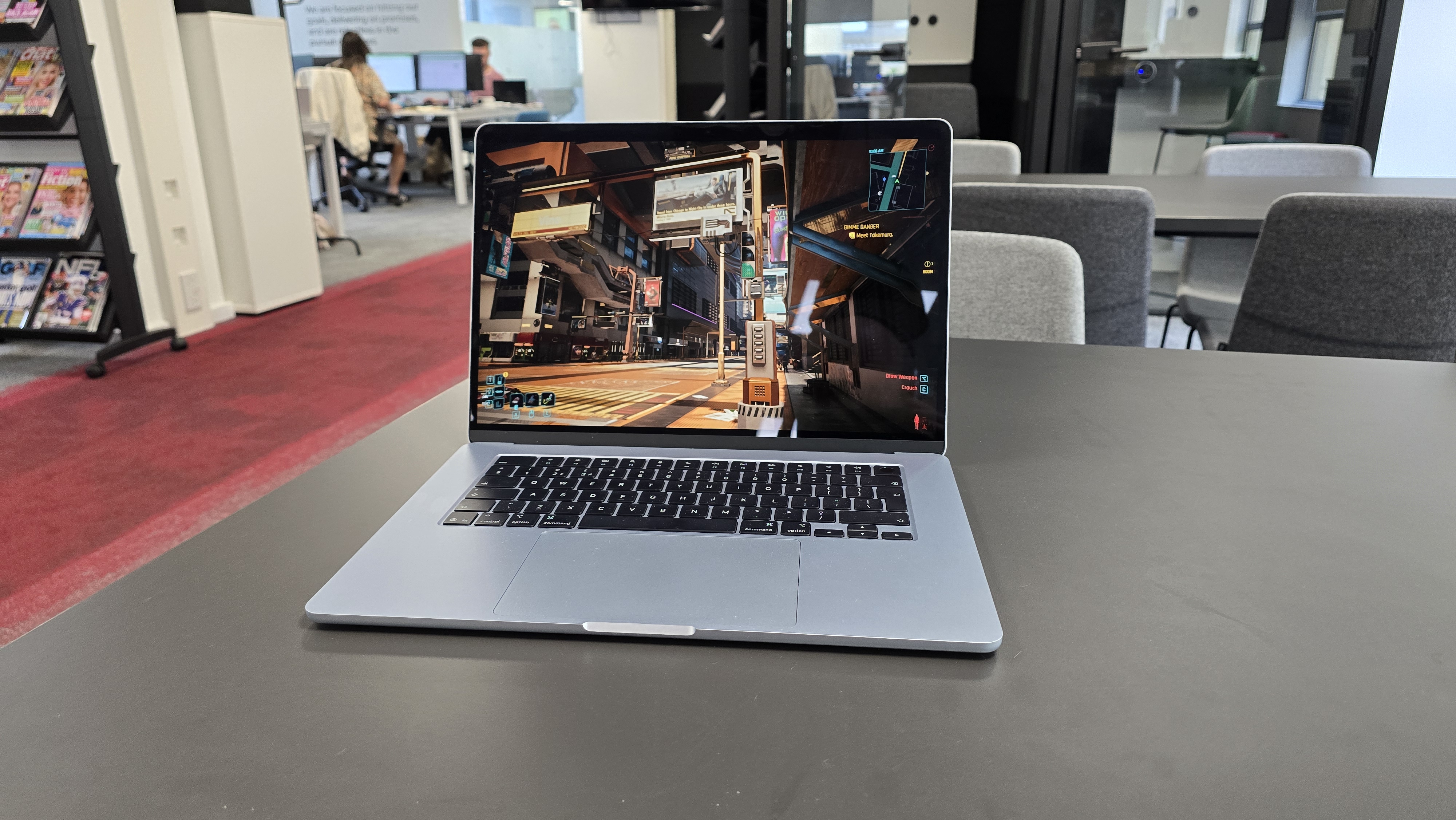 Cyberpunk 2077 on a MacBook in an office