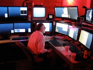 Astronomer Robert McMillan, discoverer of asteroid 2005 YU55, sits in the SPACEWATCH control room on Kitt Peak.