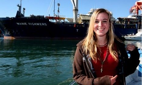 16-year-old Sunderland poses in front of her boat.