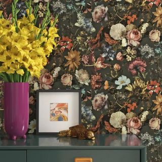 Floral wallpaper behind a table from Wayfair