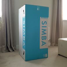 A Simba mattress in its blue and white branded box