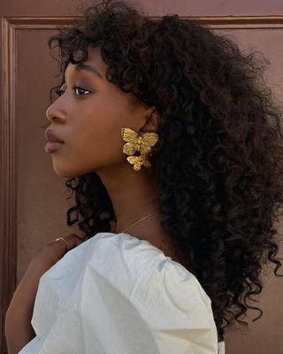 Emmanuelle Koffi with wind-swept curls