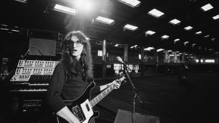 Geddy Lee, singer and bassist with Canadian rock band Rush, holding his bass guitar on stage during a soundcheck ahead of the band's gig at Bingley Hall in Stafford, Staffordshire, England, United Kingdom, 21 September 1979.